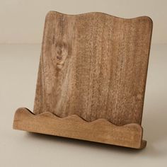 a wooden object with wavy edges on a white surface