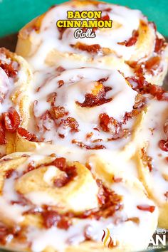 bacon cinnamon rolls with white icing in a green bowl