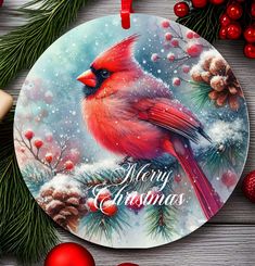 a christmas ornament with a red cardinal on it and pine cones around it