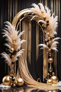 a black and gold party decoration with white feathers, balls, and decorations on the table