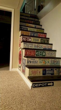 there is a staircase made out of books on the carpeted floor in front of an open door