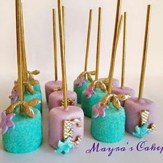 there are some little cakes that have gold sticks sticking out of them