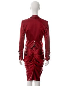 For Sale on 1stDibs - ▪ Christian Dior red satin skirt suit ▪ Designed by John Galliano ▪ Fall-Winter 2003 ▪ Constructed from red satin and leather ▪ Single-breasted jacket