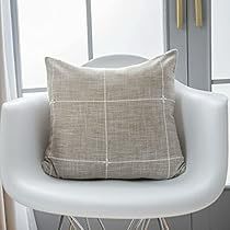 a white chair with a pillow on top of it