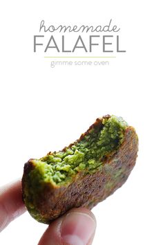 someone holding up a piece of food with pesto on it and the words homemade falafel above it