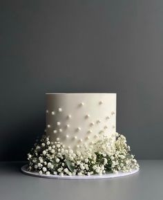 a white wedding cake with baby's breath flowers