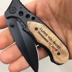 a person holding a knife in their hand with the words forever and always engraved on it