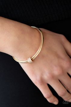 A white rhinestone encrusted fitting glides along a trio of gold bangles, creating a solitaire bracelet around the wrist.

 Sold as one individual bracelet. Bracelets Stacked, Live Text, Solitaire Bracelet, Jewelry Roll, Gold Bangles Design, Gold Bracelets, Gold Bracelet Cuff, Jewellery Ideas, Rhinestone Ring