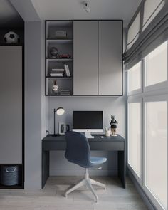 a desk with a computer on top of it in front of a window and some bookshelves