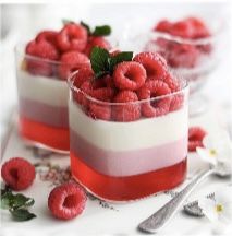 raspberry trifle in small glass dishes with spoons and forks on the side