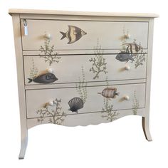 an image of a chest of drawers with fish on it