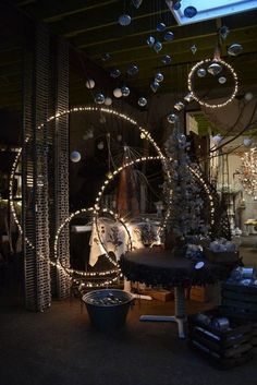 christmas lights are hanging from the ceiling in front of a store window with an assortment of items on display