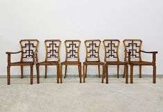 six chairs are lined up against a wall