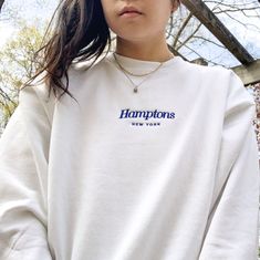 "\"Hamptons New York\" embroidered on a comfy vintage-style crewneck. If you're on the lookout for both style and comfort, this fleece sweatshirt is the perfect choice. And with up to 5% recycled polyester in components, you'll be taking a little step closer to a more earth-friendly way of life. *Sizes Are Unisex * 50% cotton, 50% polyester (up to 5% recycled polyester, made from plastic bottles) * Fabric weight: 7.8 oz/y² (264.5 g/m²) * Patented low-pill, high-stitch density PrintPro® XP fleece Embroidered Crew Neck Sweatshirt In Relaxed Fit, Relaxed Fit Embroidered Crew Sweatshirt, Basic Relaxed Fit Sweatshirt With Embroidered Text, Everyday Crew Neck Sweatshirt With Embroidered Text, Relaxed Fit Crew Neck Sweatshirt With Embroidered Text, Hamptons Sweatshirt, New York Sweater, Autumn Tops, Branded Apparel