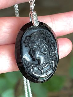 "Big, long, cameo, oval, natural, black onyx pendant necklace set in 925 sterling silver, with 18\" sterling silver chain. Stone Size: 40mm x 30mm. 17 Grams Stone Weight/85-carats." Black Round Cameo Jewelry, Black Intaglio Jewelry As A Gift, Black Cameo Medallion Jewelry, Black Cameo Medallion Necklace, Black Cameo Necklace As A Gift, Black Cameo Jewelry As A Gift, Black Cameo Necklace Gift, Black Cameo Jewelry For Gifts, Black Cameo Necklace For Gift