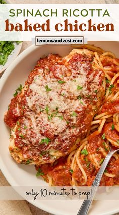 a white plate topped with spaghetti and meat covered in marinara sauce next to a fork