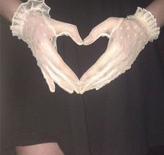 two hands in the shape of a heart made out of white gloves on top of a woman's chest