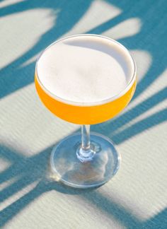 an orange and white drink sitting on top of a table