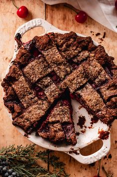 a piece of pie on a plate with cherries