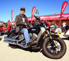 a man sitting on top of a motorcycle