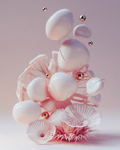 an abstract sculpture made up of white and pink objects with gold balls floating around it