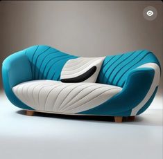 a blue and white couch sitting on top of a table