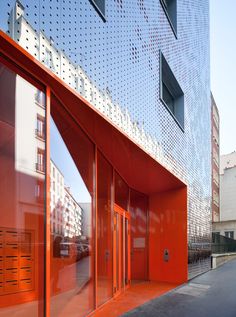 an orange building with many windows on the side