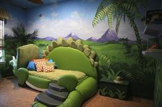 a green couch sitting in front of a window next to a painting on the wall