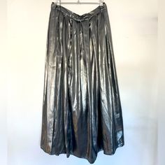 Beautiful Silver Maxi Pleated At Waistband Back Zipper Lined In Black Lots Of Movement Lightweight Shiny Silky Full Waist 15.5” Length 33” This Skirt Can Be Dressed Up Or Down. Silver Is The Color Of ‘24 Please Don’t Hesitate To Ask Questions Happy Shopping And Please Check Out My Other Listings. Metallic Pleated Bottoms For Party, Metallic Summer Skirt, Metallic Pleated Skirt Bottoms For Spring, Metallic Pleated Skirt For Spring, Spring Metallic Pleated Skirt, Metallic Skirt For Summer, Metallic Pleated Evening Skirt, Elegant Metallic Pleated Bottoms, Metallic Skirt For Evening