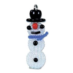 a glass beaded snowman ornament hanging on a white wall with a black hat and red nose