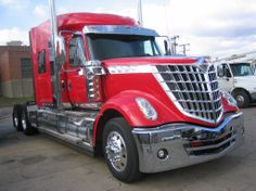 a red semi truck parked in a parking lot