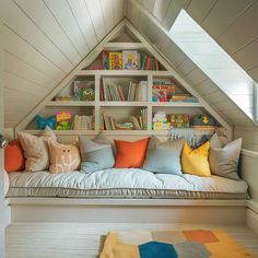 a room with a couch, bookshelf and rug on the floor in front of it