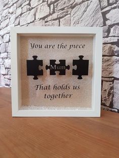 a white frame with two pieces of puzzles in it and the words you are the piece, that holds us together