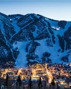 a city nestled in the mountains at night