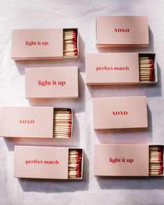 six matches are lined up in pink boxes with the words light it up, perfect match, and xoxo written on them