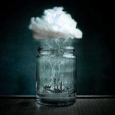 a glass jar filled with water sitting on top of a wooden table