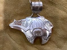 "Vintage Beautiful Native American Navajo Sterling Silver Bear. This piece measures 1 7/8\"inches in length and measures 1 7/8\"wide. Can be worn as a necklace with the Silver chain it comes with. Hallmarked on the back by the Artist and stamped sterling.❤️ As a Native American symbol, the bear is as free in spirit as the great wind; and as grand as the universe within it lives. To match this magnitude, the bear also has a quality of unpredictability. To explain, we're talking about a massive an Southwestern Style Hand Tooled Necklace As Gift, Native American Symbol, Storm Brewing, Spirit Bear, Native American Symbols, Silver Bear, Silver Clay, American Indian Jewelry, Southwest Jewelry