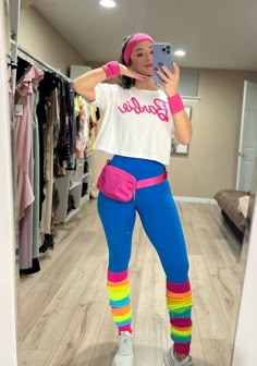 a woman is taking a selfie in the mirror while wearing colorful leggings