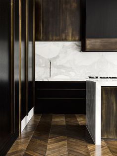 a kitchen with wooden cabinets and marble counter tops