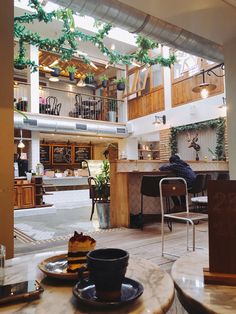 the inside of a restaurant with tables and chairs