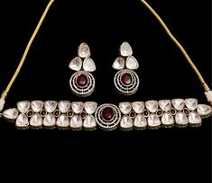 The Tayani Kundan necklace features a stunning Red Ruby stone adorned with intricate AD stones and. Paired with long, lightweight earrings, it exudes elegance and charm, making it a statement piece for any occasion. necklace adjustable (backside an adjustable coard) push back earrings Red Ruby Kundan Necklace For Celebration, Ruby Gemstone Kundan Necklace For Wedding, Festival Kundan Necklace With Ruby, Festive Red Ruby Kundan Necklace, Red Kundan Gemstone Necklace, Indian Choker Necklace, Indian Necklace, Kundan Necklaces, Ruby Stone