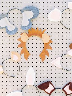 some paper cut outs are arranged on a white surface with holes in the middle to make them look like flowers