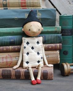 a doll sitting on top of some books