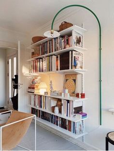 a living room filled with lots of books and furniture