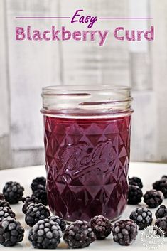 blackberry curd in a mason jar surrounded by blackberries on a white surface with text overlay