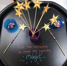 a tray that has some sticks and stars on it with words written in the middle