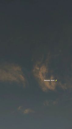 an airplane is flying in the sky at night with moon and clouds behind it on a cloudy day