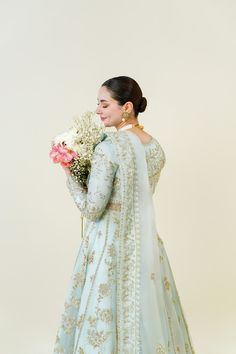 An embodiment of ethereal grace. A beautiful festive design in the captivating signature long panelled Agha Noor pishwas silhouette, crafted from pure soft organza heavily embellished with gold zardozi craftsmanship, each stitch is a testament to generations of artistry. Completing the Azeena masterpiece is a soft pure Semi-stitched Gold Kurta With Naqshi, Designer Gold Anarkali Set With Intricate Embroidery, Wedding Kurta With Resham Embroidery In Chinon, Festive Organza Lehenga With Naqshi Detailing, Gold Raw Silk Dupatta With Naqshi Embroidery, Gold Naqshi Raw Silk Dupatta, Gold Raw Silk Dupatta With Naqshi Detail, Gold Anarkali Set With Intricate Embroidery For Eid, Semi-stitched Gold Anarkali Set With Intricate Embroidery