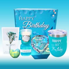 a blue birthday gift box with candles, candle holders and greeting cards for someone special