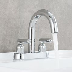 a faucet with water running from it's side spout in a bathroom